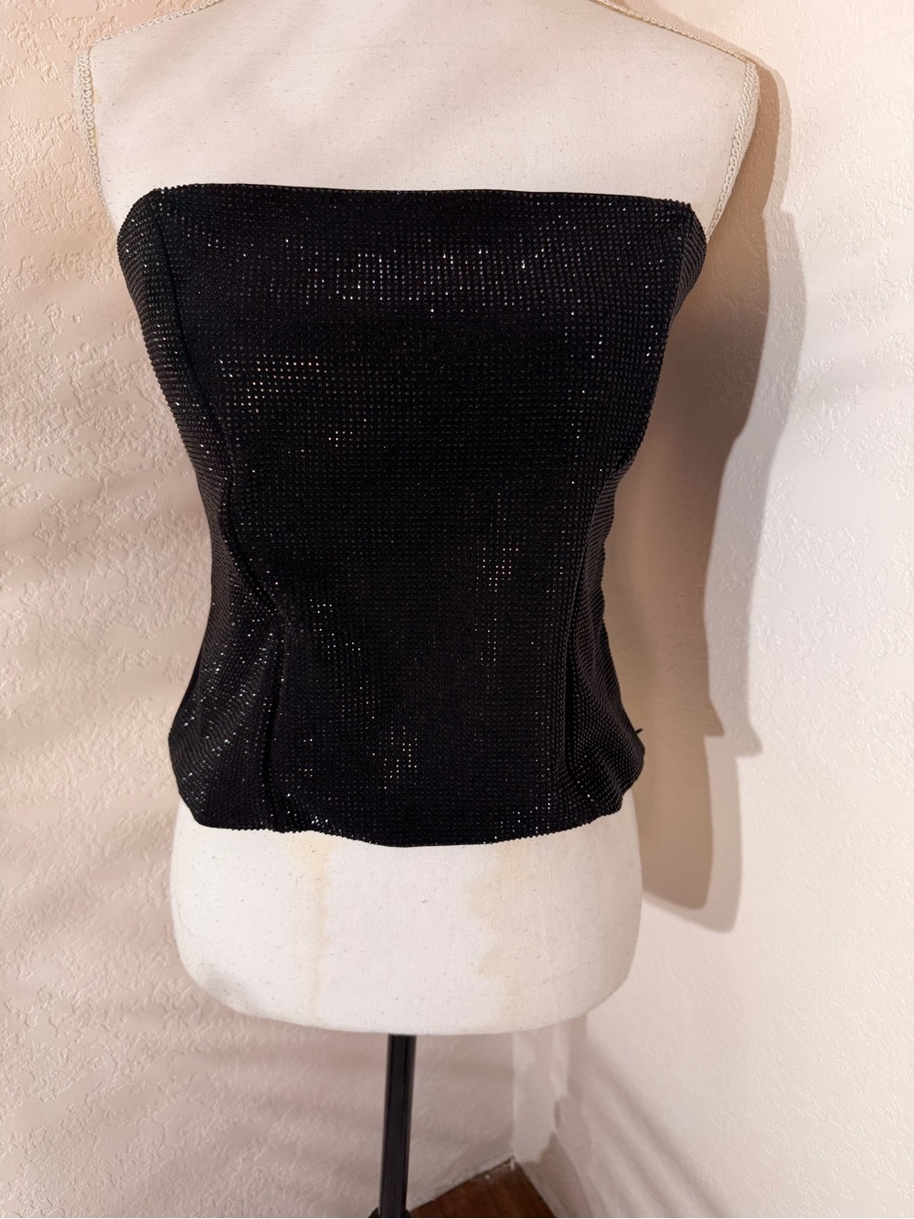 Glam Black sleeveless top with black rhinestone embellishments.